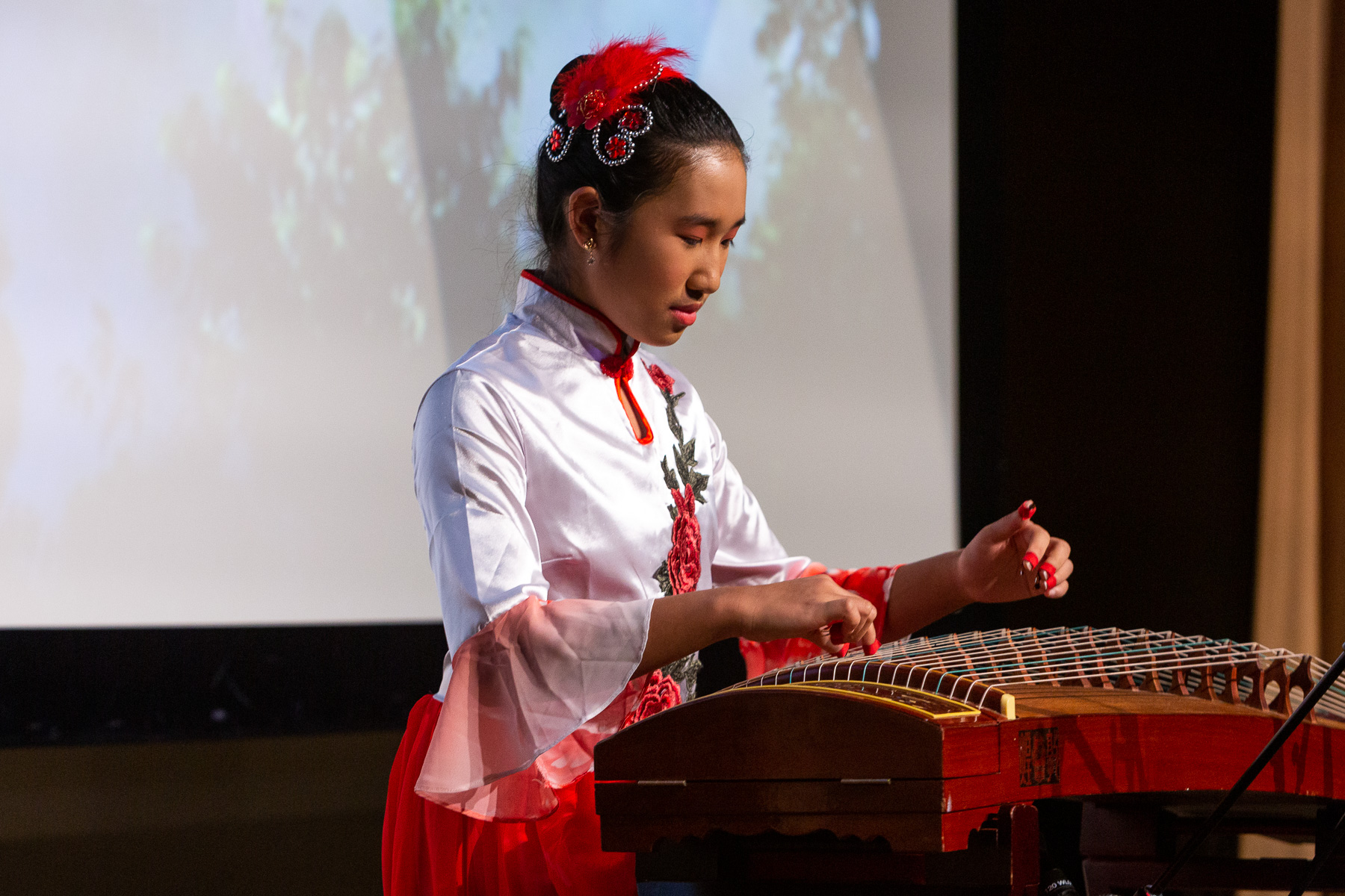 DePaul student Angela Wang performs “Dance of the Yi People,” using a traditional guzheng string instrument. (DePaul University/Randall Spriggs)